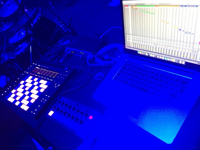 Illuminated pad controller and laptop on stage