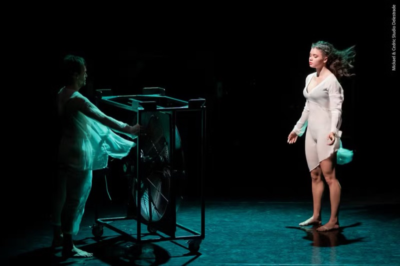 Emilio Calcagno's Storm: a dancer facing a fan on a dark stage